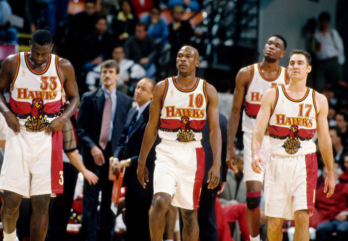 Feb 14, 1997; Atlanta, GA, USA; FILE PHOTO; Atlanta Hawks guard Mookie Blaylock (10), Tyrone Corbin (33), Jon Barry (17) and Dikembe Mutombo (55) against the Chicago Bulls at the Omni.